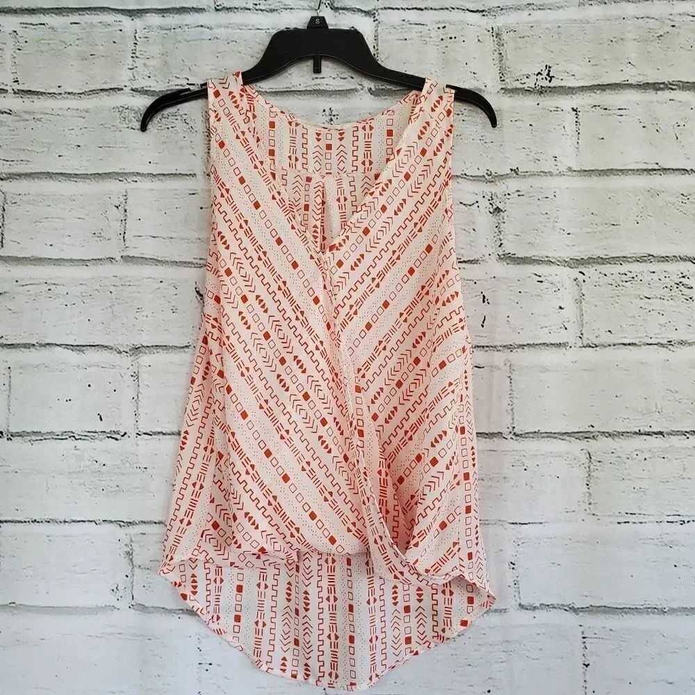 Lush geometric sleeveless faux wrap front shirt